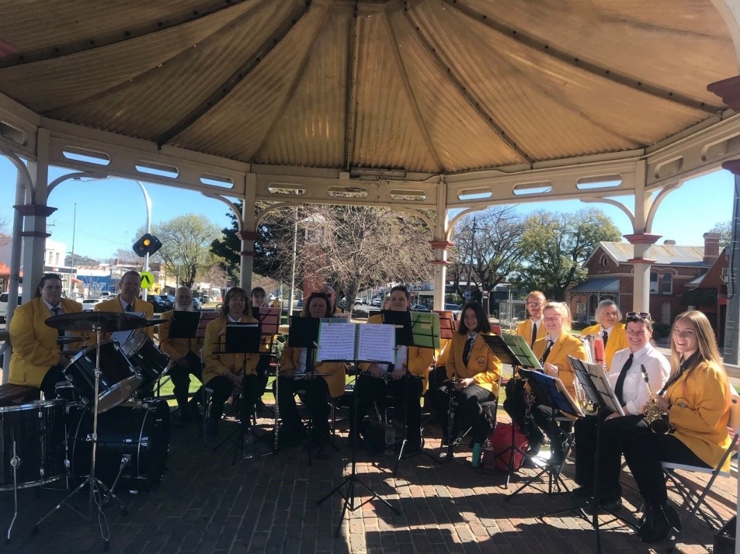 Maffra Municipal Band members in uniform at the Maffra Band Rotunda, in position, with instruments in hand and ready to play